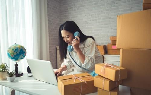 small-business-woman-boxes-on-phone