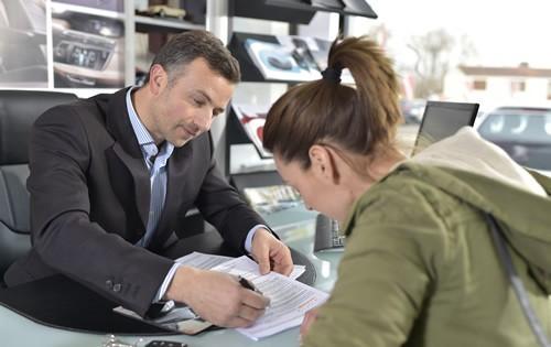 car-loan-man-woman-signing-documents