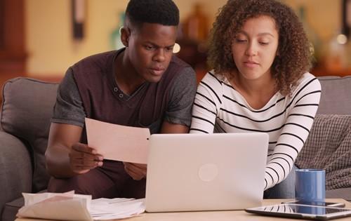 man-woman-paying-bills-computer