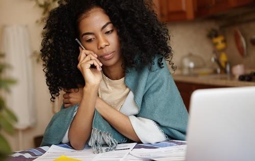 woman-upset-on-phone-house