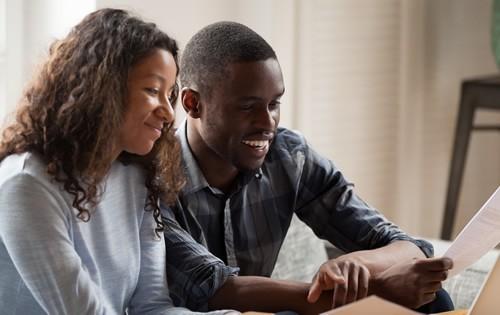 Happy couple reading a document