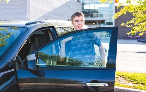 Young man and a car at college