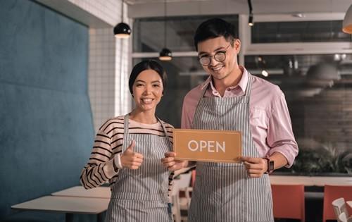 man-woman-holding-sign-business