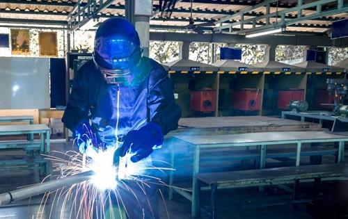 Person welding at a factory