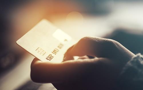 gold-credit-card-holding-hand.jpg